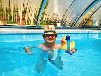 Portrait of boy swimming in pool