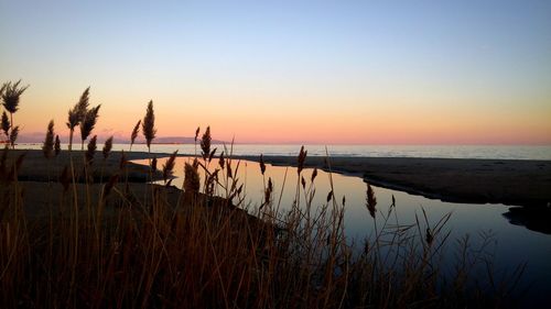 Scenic view of sea against clear sky during sunset