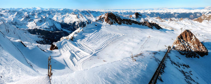 Aerial view of snowcapped mountains against sky