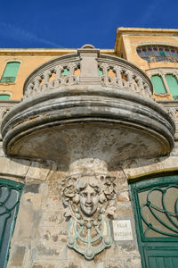 Low angle view of statue against building