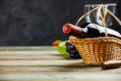 Close-up of wine bottle in basket on table