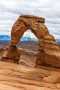 View of rock formation against cloudy sky