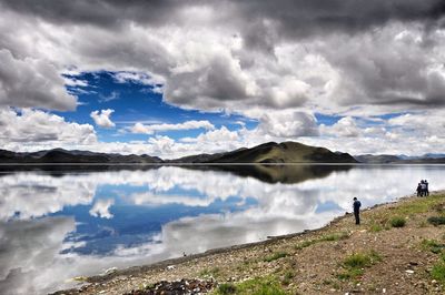 Scenic view of lake against cloudy sky