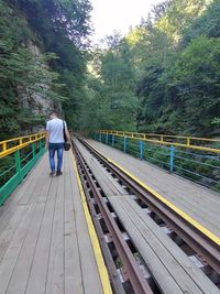 Rear view of man on railroad track