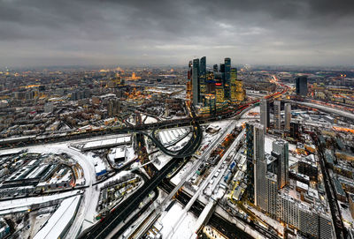 High angle view of highway amidst buildings in city against sky