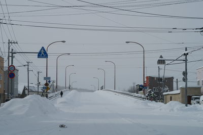 Snow covered road against sky