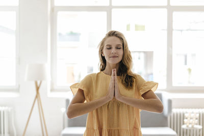 Young woman wearing a dress practising yoga