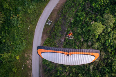 High angle view of man paragliding over landscape