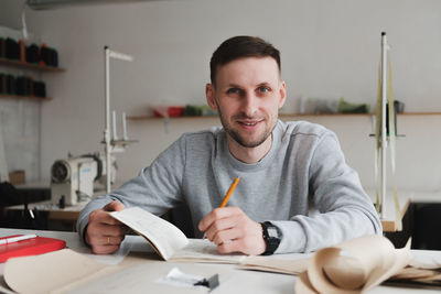 Portrait of man sitting at table