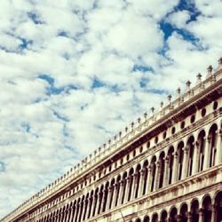 Low angle view of historical building against cloudy sky