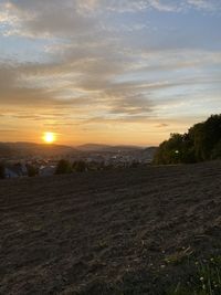 Scenic view of field against sky during sunset