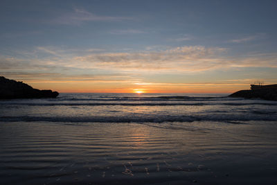 Scenic view of beach at sunset