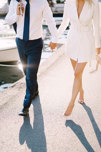 Low section of women walking on street