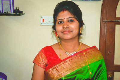 Portrait of mid adult woman wearing sari while standing at home