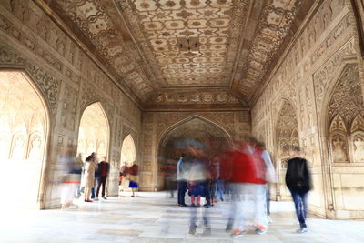 People walking in corridor of building