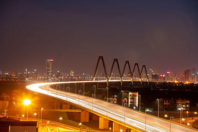 High angle view of illuminated bridge against sky at night