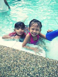 Portrait of happy boy playing in swimming pool