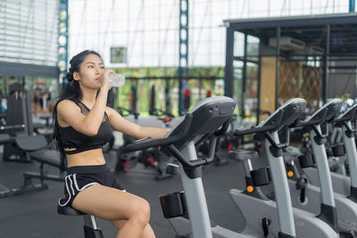 Young woman exercise bike at gym