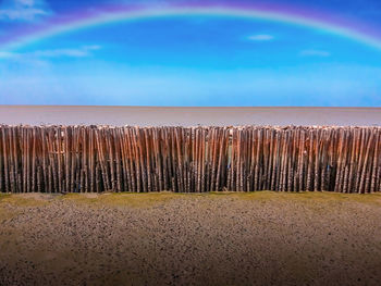 Close-up of sand at beach against sky