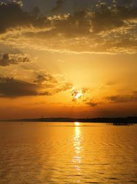 Scenic view of sea against orange sky