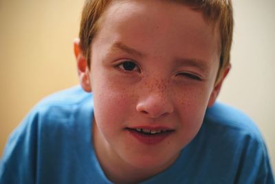 Close-up portrait of boy winking