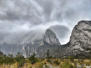 Scenic view of mountains against cloudy sky