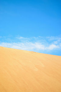 Scenic view of desert against blue sky