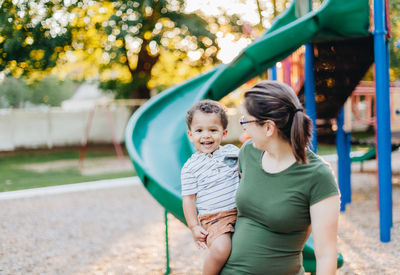 Mother and diverse mixed race toddler so. at park having fun bonding together