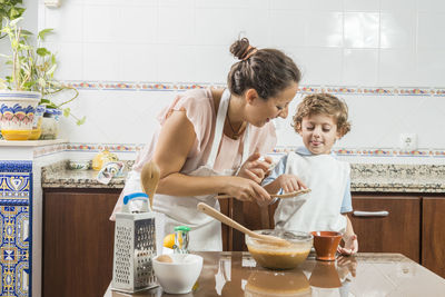 Mother and daughter in traditional clothing at home