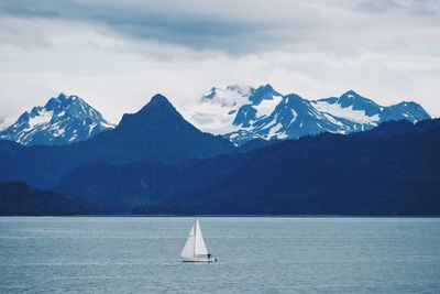 Sailboat sailing in sea against sky