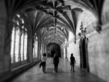 People walking in corridor of building