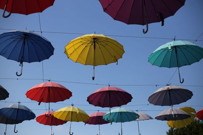 Low angle view of umbrellas against sky