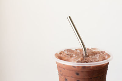 Close-up of coffee cup against white background