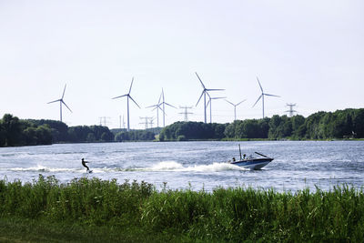 Crane on shore against sky