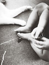 Low section of mother and son on rug