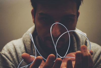 Close-up portrait of man holding camera