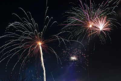 Low angle view of firework display at night