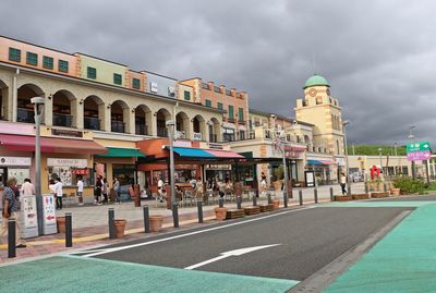 People walking on street against buildings in city