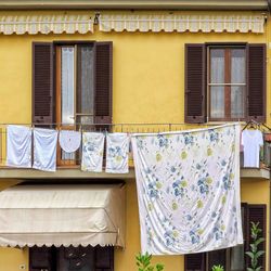 Low angle view of clothes drying against building