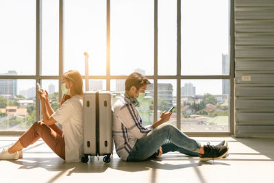 Young couple sitting on window