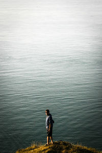 Full length of man standing against lake