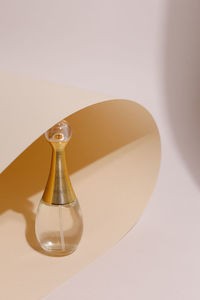 Close-up of perfume on colored background