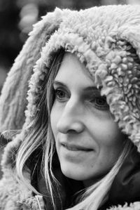 Close-up of smiling woman in warm cloths