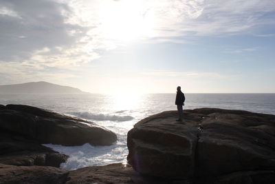 Man looking at sea against sky