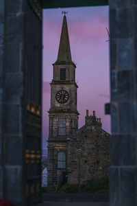 Low angle view of clock tower against sky during sunset