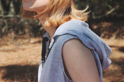 Side view of woman wearing hat on field