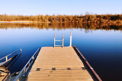 Pier over lake against sky