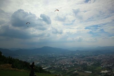People flying over landscape