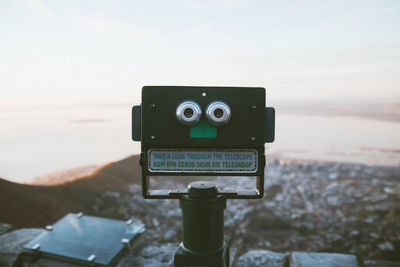 Close-up of camera against the sky