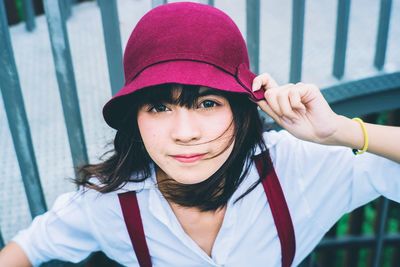 Portrait of smiling young woman wearing hat